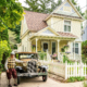 The Barns Into Birdhouses office shown with a classic car in the driveway.